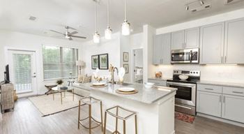 Open-concept floor plan looking across the gourmet kitchen and living room The Retreat at Fairhope Village in Fairhope, AL
